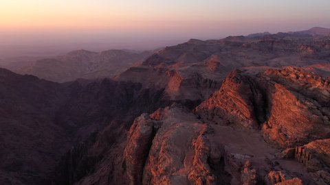 Aerial footage of the sunset over the mountains in ancient Petra city, Jordan