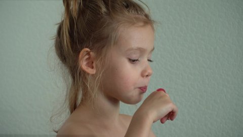 Little girl sucks sweet fruit lollipop. Child eats caramel candy. Chupa Chups. Sweetness