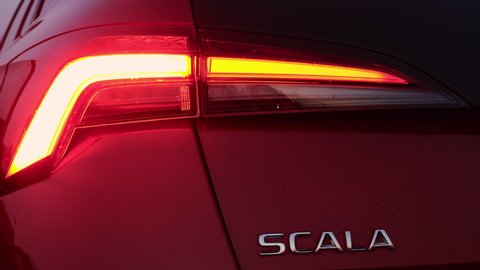 A fast blinking animated turn signal of headlight of a red car Skoda Scala, December 2021, Prague, Czech Republic.