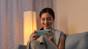 Asian woman using the smartphone at home at night