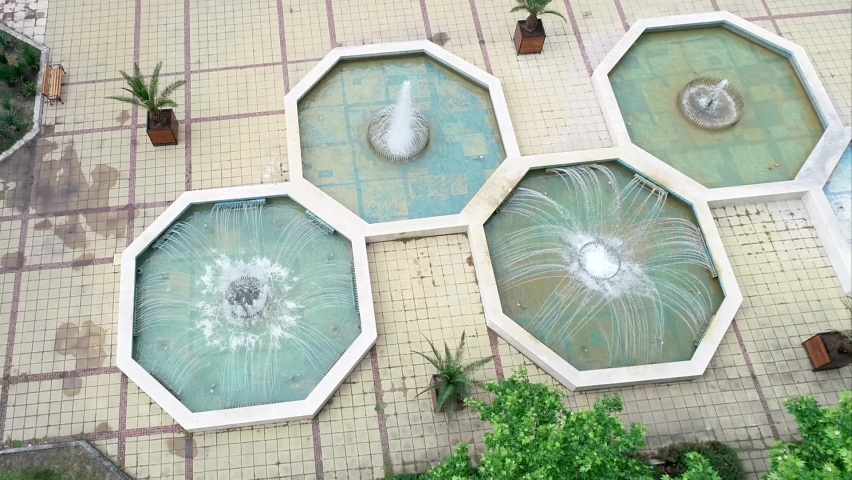 Aerial view over the fountain on the square in the center of the city