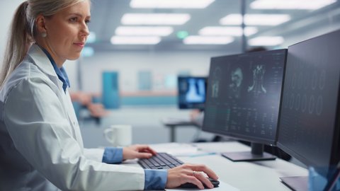 Medical Hospital Research Lab: Female Neurosurgeon Using Computer with Brain Scan MRI Images, Finding Best Treatment for Sick Patient. Health Care Neurologist Analysing CT Scan. Arc Portrait