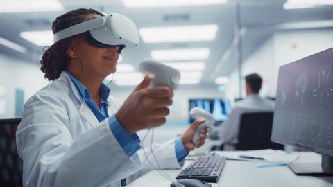 Futuristic Medical Hospital: Neurosurgeon Wearing Virtual Reality Headset Uses Controllers to Remotely Operate Patient with Medical Robot. Modern High-Tech Advance in Breakthrough Medical Treatment