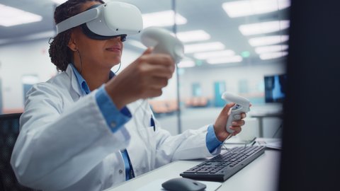 Futuristic Medical Hospital: Black Female Neurosurgeon Wearing Virtual Reality Headset Uses Controllers to Remotely Operate Patient Using Medical Robot. High-Tech Treatment of Neurological Disease