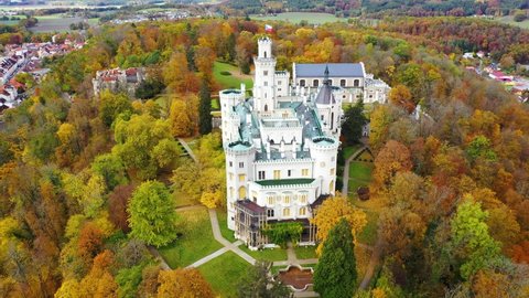 Castle Hluboka nad Vltavou is one of the most beautiful castles in Czech Republic. Castle Hluboka nad Vltavou in autumn with red foliage, Czechia. Colorful autumn view of Hluboka nad Vltavou castle.