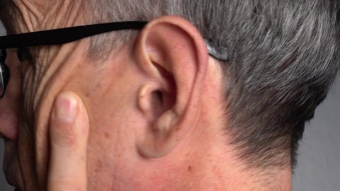 The ear of an elderly man in close-up. Ear canal, lateral view.