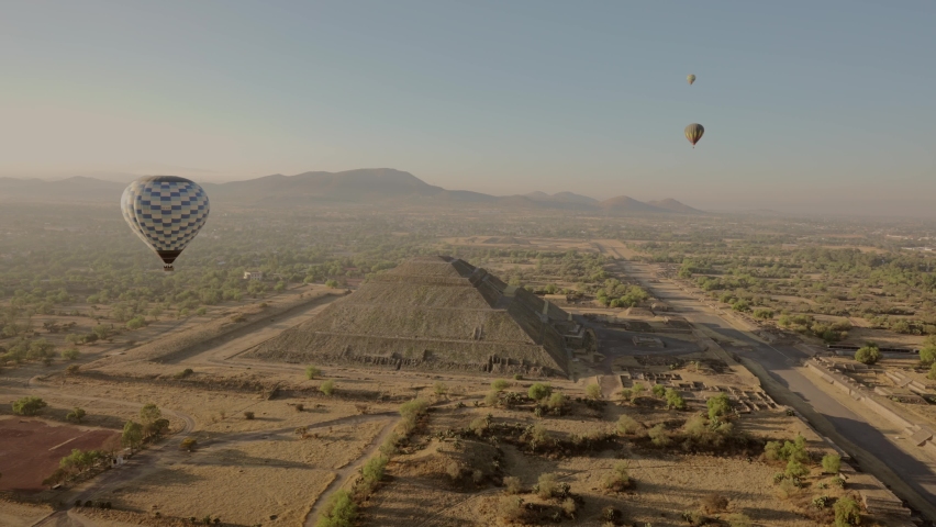 Beautiful aerial view of Pyramid of the Sun with sunrise and air balloons in  Teotihuacan, Mexico.