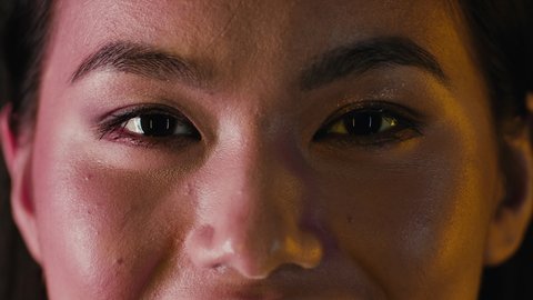 Closeup Unedited Shot Of Asian Female Eyes With Natural Makeup, Cropped Portrait Of Young Korean Woman With Unaltered Beautiful Skin Looking At Camera And Smiling, Slow Motion Footage