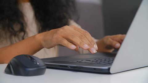 Black business woman typing on computer. Freelancer female doing distant work on laptop. Professional free lance writer types text on notebook. Person working from home on lockdown in 4k stock video