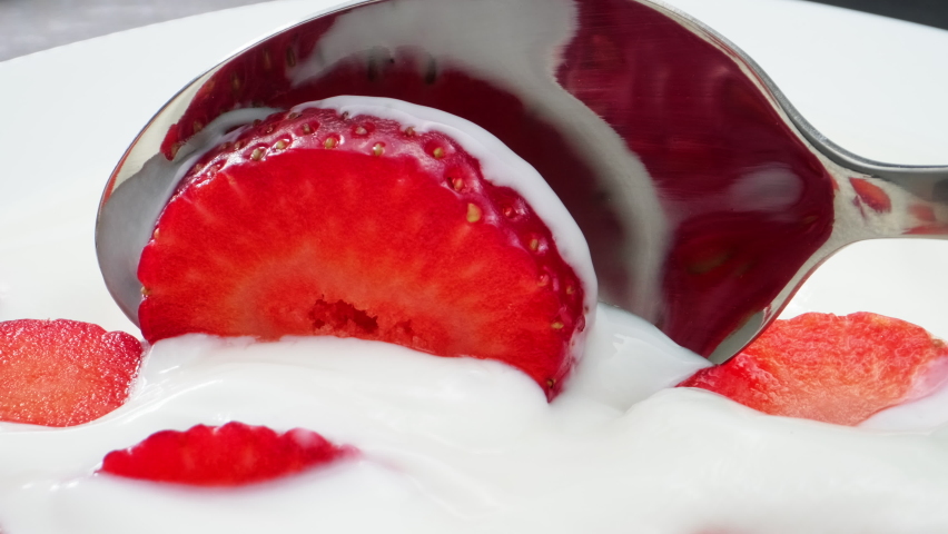 Spoon in yogurt with strawberries. High quality 4k footage | Shutterstock HD Video #1085136701