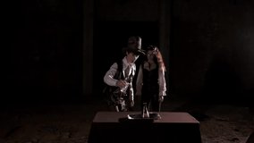 A male alchemist pours a reagent into a flask. There is a chemical reaction and an explosion. The man runs back. The girl is watching - Powered by Shutterstock - Get 15% off with code: PIKWIZARD15