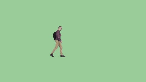 An adult man with a backpack walks through the frame. Alpha channel background