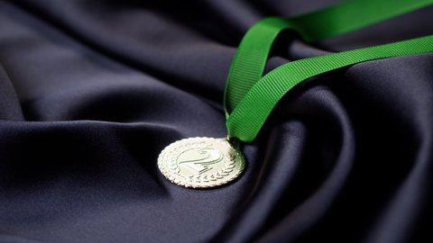 Silver medal with ribbon on black background close-up. The second place. Award and victory, winning the championship. 
