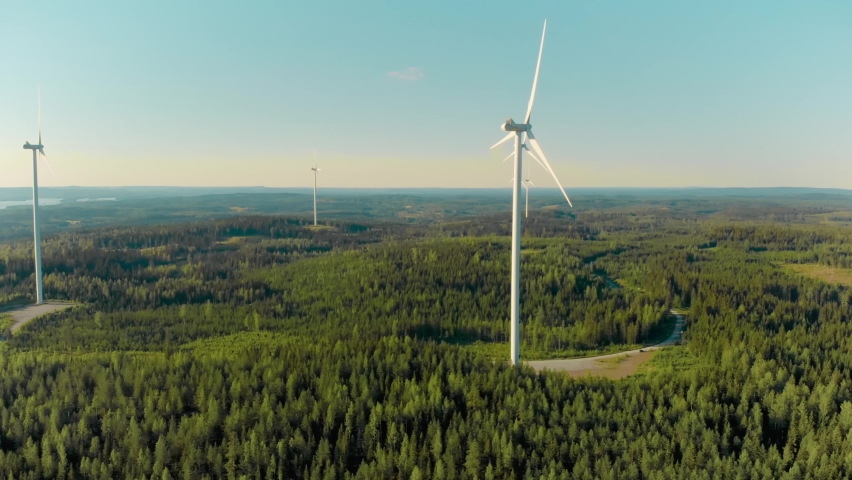 Aerial drone view of Finland forest landscape and wind turbines generating clean renewable energy. Wind farm and green electricity production in Europe and nordic countries. Royalty-Free Stock Footage #1085144591