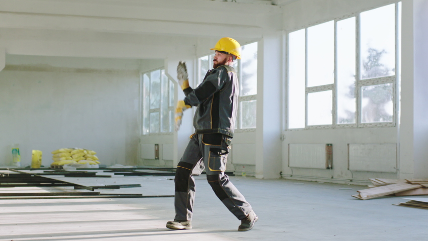 Happy and excited construction worker at construction site dancing and enjoy the moment he wearing uniform and safety helmet | Shutterstock HD Video #1085146886