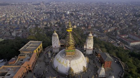 Flying backwards tilting down towards Swayambhunath Stupa in Kathmandu Nepal.