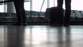 4K ground level soft focus video clip of anonymous people walking through an airport terminal with suitcases, bags and baggage