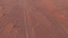 Aerial footage of Wadi Rum desert in Jordan during a beautiful sunrise with the red rocks in the background