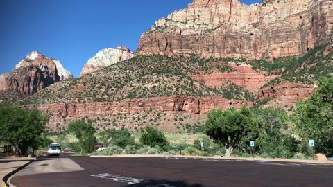 Utah, USA- July 2018: Wide hand-held shot of the Zion National park free shuttle bus driving by.