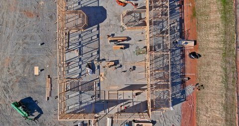 Aerial view of elevator shaft for concrete block building under construction work on workers are laying blocks the a beams house residential under construction