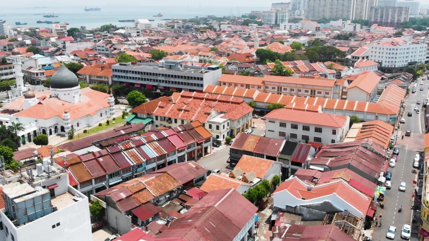 Forward Flying Drone Shot Over George Town City, Showing The Sea With Boats In The Background. George Town, Penang in Malaysia