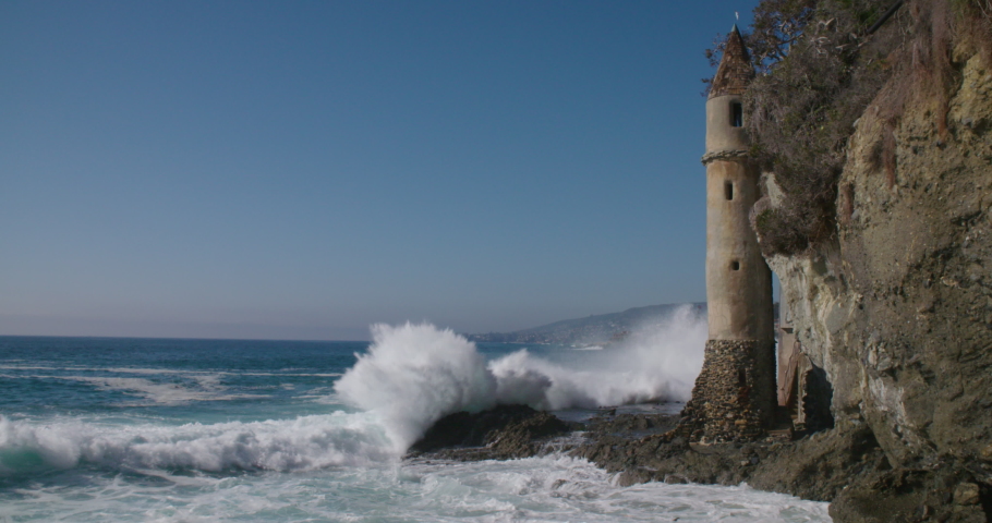 Waves crashing against the Pirate Tower landmark at Victoria Beach in Laguna Beach, California.