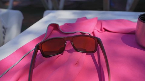 sunglasses and towel. Towel on a sandy beach with sunglasses on the table