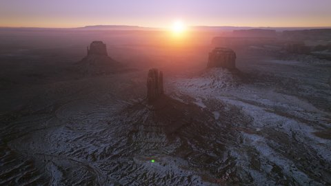 Scenic golden sunrise above Monument valley rock formations in Navajo Tribal park in Utah USA. Aerial drone view of famous landmark from western movies, Hollywood filming location at winter 4K footage
