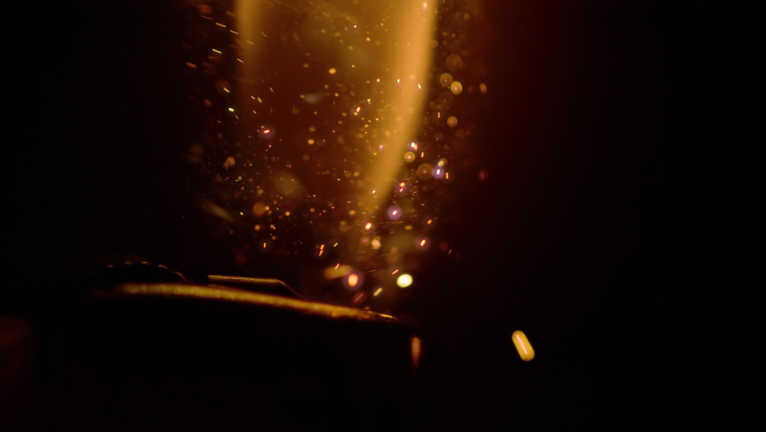 SLOW MOTION, MACRO, DOF: Macro view of a vintage steel lighter ignited in dark. Detailed close up shot of sparks flying as person ignites a lighter. Orange flame rises from a lighter lit up at night. | Shutterstock HD Video #1085173043