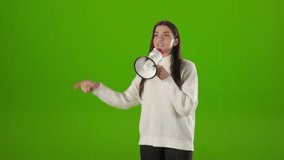 Casually dressed caucasian woman standing over chroma key background and talking in loudspeaker. Female boss giving commands and gesturing indoors. - Powered by Shutterstock - Get 15% off with code: PIKWIZARD15