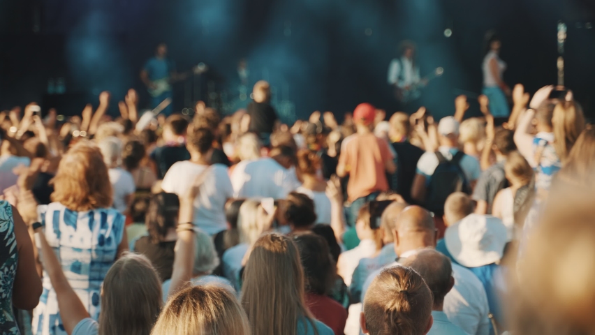 People enjoying musical concert on large stage. Royalty-Free Stock Footage #1085179625