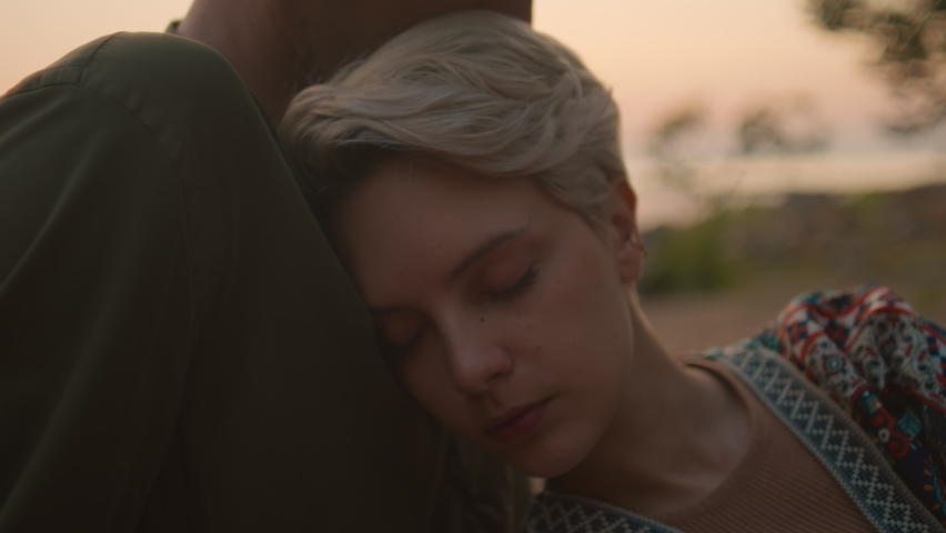 Cinematic close up shot of young woman rest in arms of loved one, beautiful couple embraced in hug. Concept affectionate and healthy modern relationship, warmth and compassion, soft focus | Shutterstock HD Video #1085182853