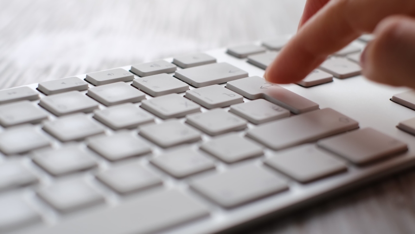 Finger pressing an enter key. Computer user hitting the enter key, up close. Confirmation, sending a message Royalty-Free Stock Footage #1085184572