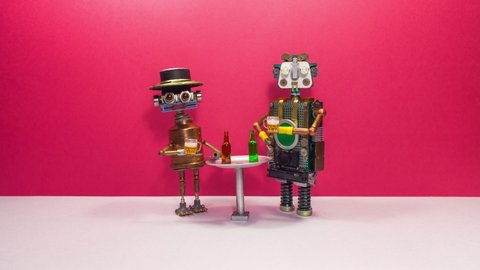 Beer party or birthday celebration. A meeting of two robot friends at a bar. Two robotic toy characters are drinking beer at the bar table, clinking glasses, gesturing and talking