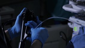 Close-up of doctor hands with endoscope and probe during diagnostic gastroscopy or colonoscopy procedure