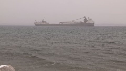 Owen sound, Ontario, Canada - December 2014 Ship /  freighter taking shelter in bay from severe wind waves and blizzard
