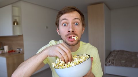Funny Surpried Man Eating Popcorn. Looking At Camera With Amazement.