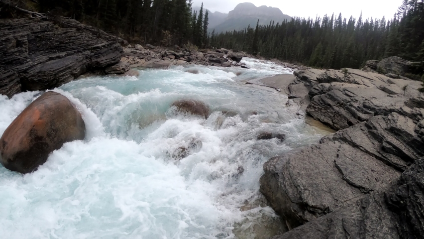 Panning, Rapids flowing in rocky Mistaya canyon at Icefields Parkway, Alberta, Canada