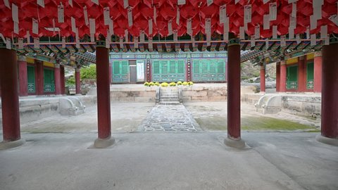 Tilt Shot of Cheongpyeongsa wooden temple of buddhist with red lamps hanging on ceiling in Gangwon-do, South Korea