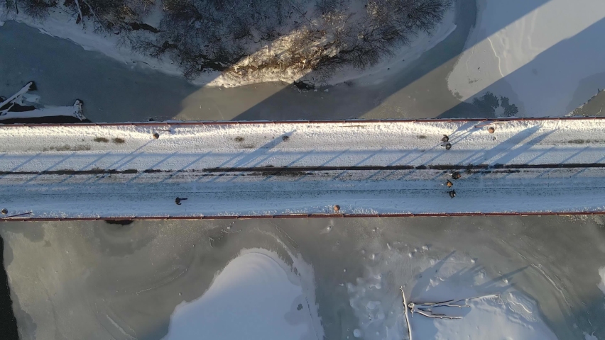 Aesthetic view of people walking at Stone Arch bridge in Minneapolis, MN on a winter afternoon