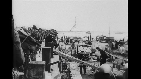 1940s: Soldiers exiting ship. Tracking shot of soldiers marching. Soldiers loading onto landing craft. Soldier waving. Soldiers on dock. Winston Churchill boarding ship. Men on ship with Churchill.
