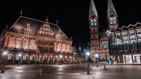 4k Timelapse of night traffic in front of historic town hall Bremen Germany with tram traffic and people moving.