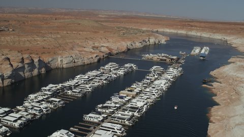 Aerial flyover view of boats in marina in Lake Powell - Page, Arizona, United States
