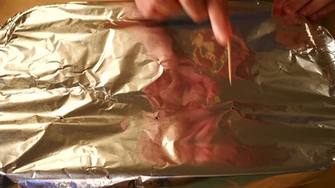 Poke Holes in Aluminium Foil with Toothpick