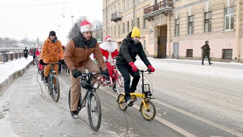 SAINT-PETERSBURG, RUSSIA - JANUARY 09 2022: Local annual IX Saint-Petersburg  Ded Moroz (Santa Claus in Russia) bicycle parade (veloparad) in the city. 