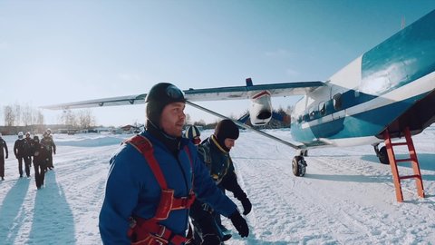 Bogorodsk, January 8, 2022. A parachutist walks through the snow to the plane in winter. Paratrooper, skydiver in winter