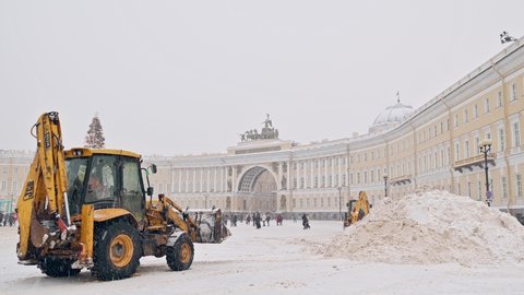SAINT-PETERSBURG, RUSSIA - JANUARY 09 2022:  Snow cleaning machines and snow mountains at Palace square.