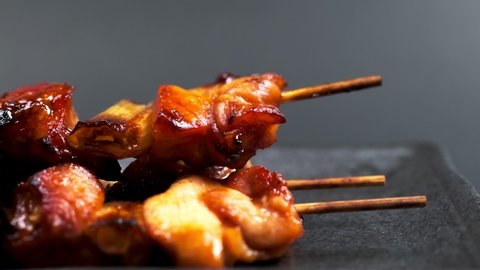 Grilled chicken on a skewer "yakitori" on a plate, Food background, Macro photograph