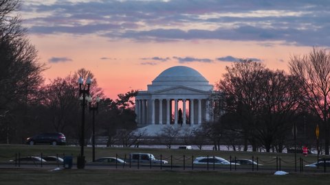 Washington, DC, USA - January 10, 2022: A time-lapse of the sun setting at the Jefferson Memorial, which is located at the Tidal Basin on the National Mall.