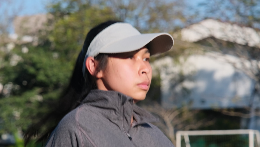 Young woman warming up exercise and stretching her muscle before jogging in the park. Athlete woman preparing for running during sunset. Sport and active lifestyle.